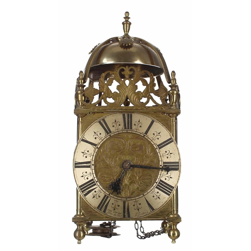 English brass verge lantern clock, the 6.25" silvered chapter ring signed Thomas Talbot, London and enclosing a foliate engraved centre, surmounted by pierced foliate frets, strapwork, bell and finial, 15" high (pendulum, weights and later oak wall bracket)