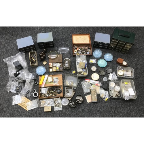 483 - Quantity of assorted clock and watch parts and spares to include ratchet wheels, mainsprings, hands,... 