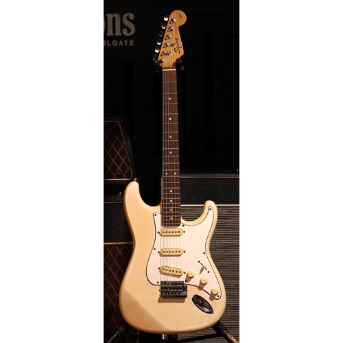 523 - Squier by Fender Strat electric guitar, made in China; Body: yellowed Olympic white finish, scuffs a... 