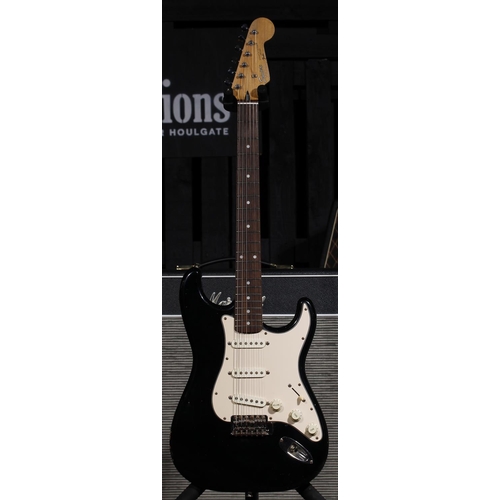 569 - Squier by Fender Stratocaster electric guitar, made in Japan, circa 1993; Body: black finish, scratc... 