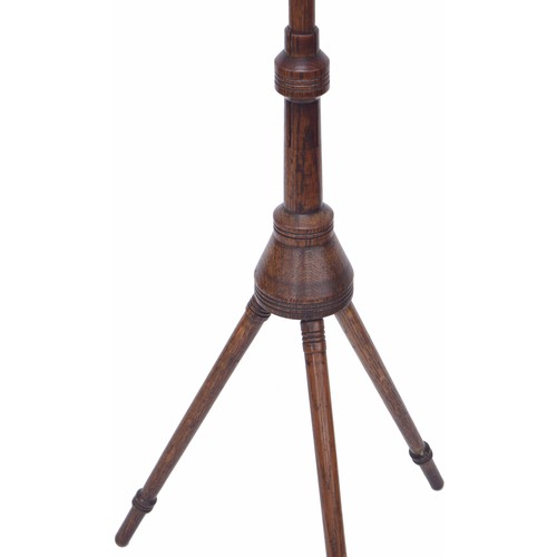 1600 - Arts & Crafts Liberty style oak adjustable tripod music stand, upon turned legs