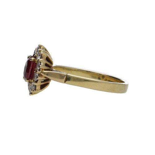 311 - Attractive 18ct yellow gold oval ruby and diamond cluster ring, the ruby 0.60ct approx, in a surroun... 