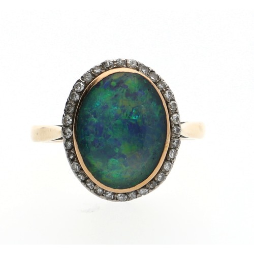 134 - Attractive 18ct yellow gold oval triplet black opal and diamond ring, the border with round-cut diam... 