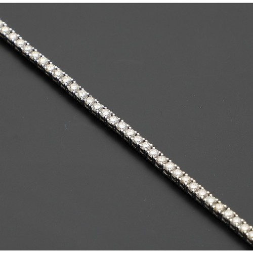 173 - Fine modern 18ct white gold diamond tennis bracelet, with eighty-four round brilliant-cuts, estimate... 