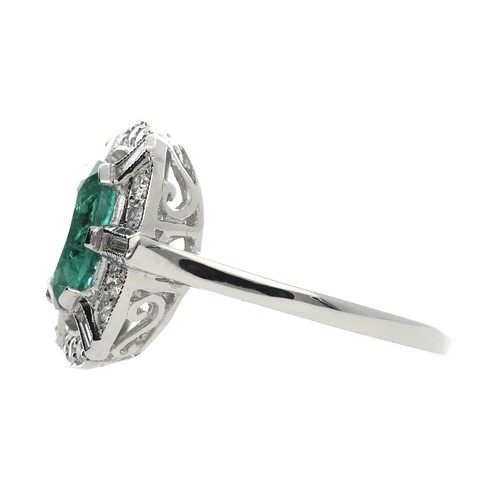 234 - Attractive platinum emerald and diamond cluster ring in a stylised Art Deco style setting, the emera... 