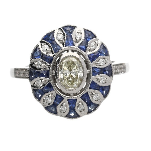 109 - Stylised modern 18ct white gold oval dress ring set, with a central oval diamond surrounded by sapph... 