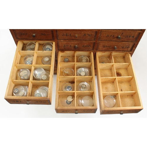 219 - Twelve drawer wooden chest containing a quantity of assorted watch glasses of various sizes, 27.25''... 