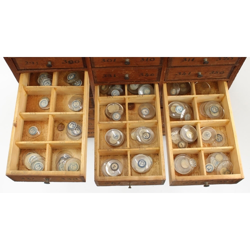 219 - Twelve drawer wooden chest containing a quantity of assorted watch glasses of various sizes, 27.25''... 