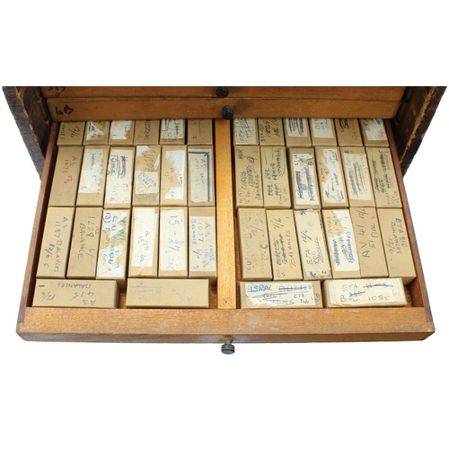 397 - Twelve drawer wooden chest containing a quantity of watch parts including balances, stems, wheels, d... 