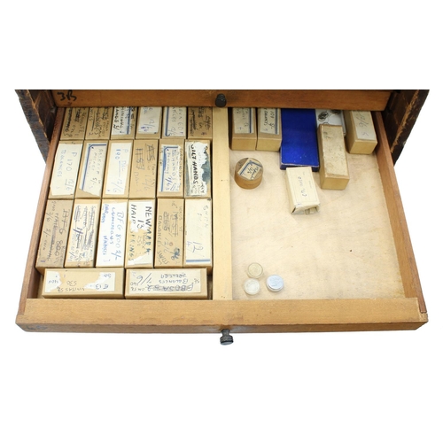 397 - Twelve drawer wooden chest containing a quantity of watch parts including balances, stems, wheels, d... 