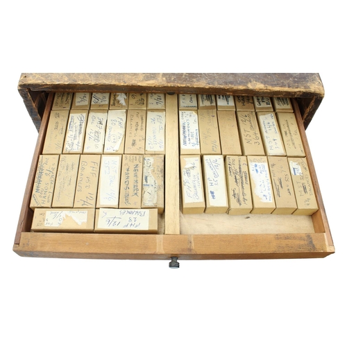 397 - Twelve drawer wooden chest containing a quantity of watch parts including balances, stems, wheels, d... 