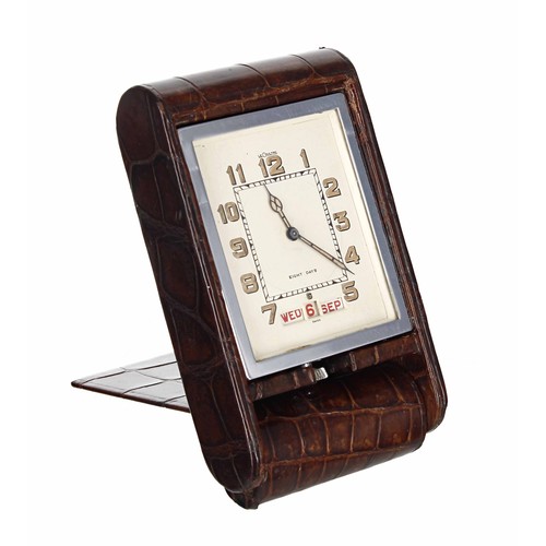 2513 - LeCoultre 8 Days travel clock with calendar, within a chrome casing and brown leather folding travel... 