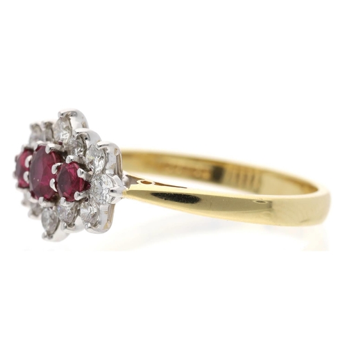 114 - Attractive 18ct yellow gold ruby and diamond cluster ring, centred with three round-cut rubies in a ... 