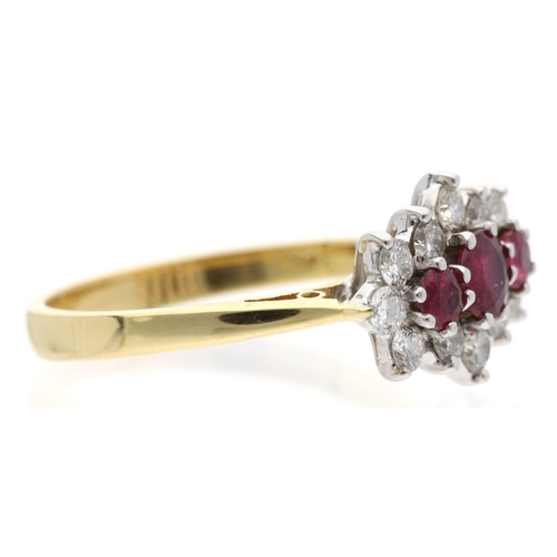 114 - Attractive 18ct yellow gold ruby and diamond cluster ring, centred with three round-cut rubies in a ... 