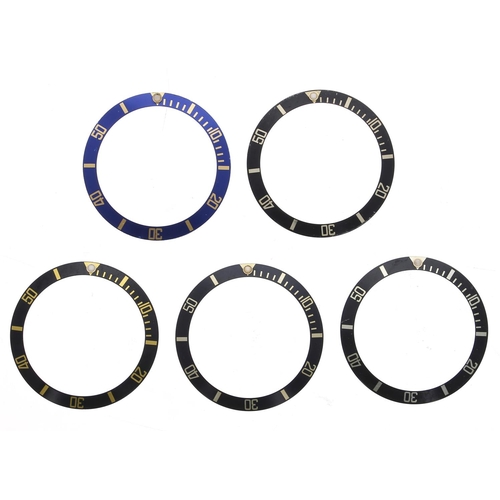 798 - Rolex - Four black bezel inserts; together with a blue bezel insert (5)