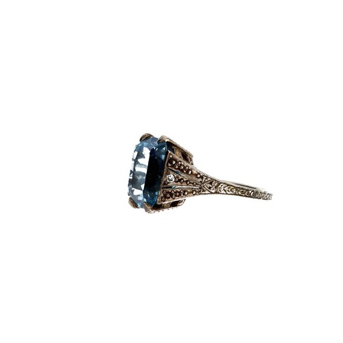 79 - White metal patterned mount large blue topaz and diamond ring, width 13.5mm, 4.9gm, ring size H/I (3... 