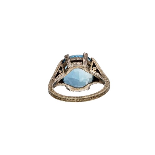 79 - White metal patterned mount large blue topaz and diamond ring, width 13.5mm, 4.9gm, ring size H/I (3... 