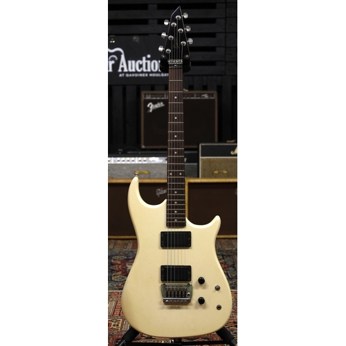 924 - 1980s Encore electric guitar; Body: pearlescent white finish, scratches and scuffs throughout; Neck:... 