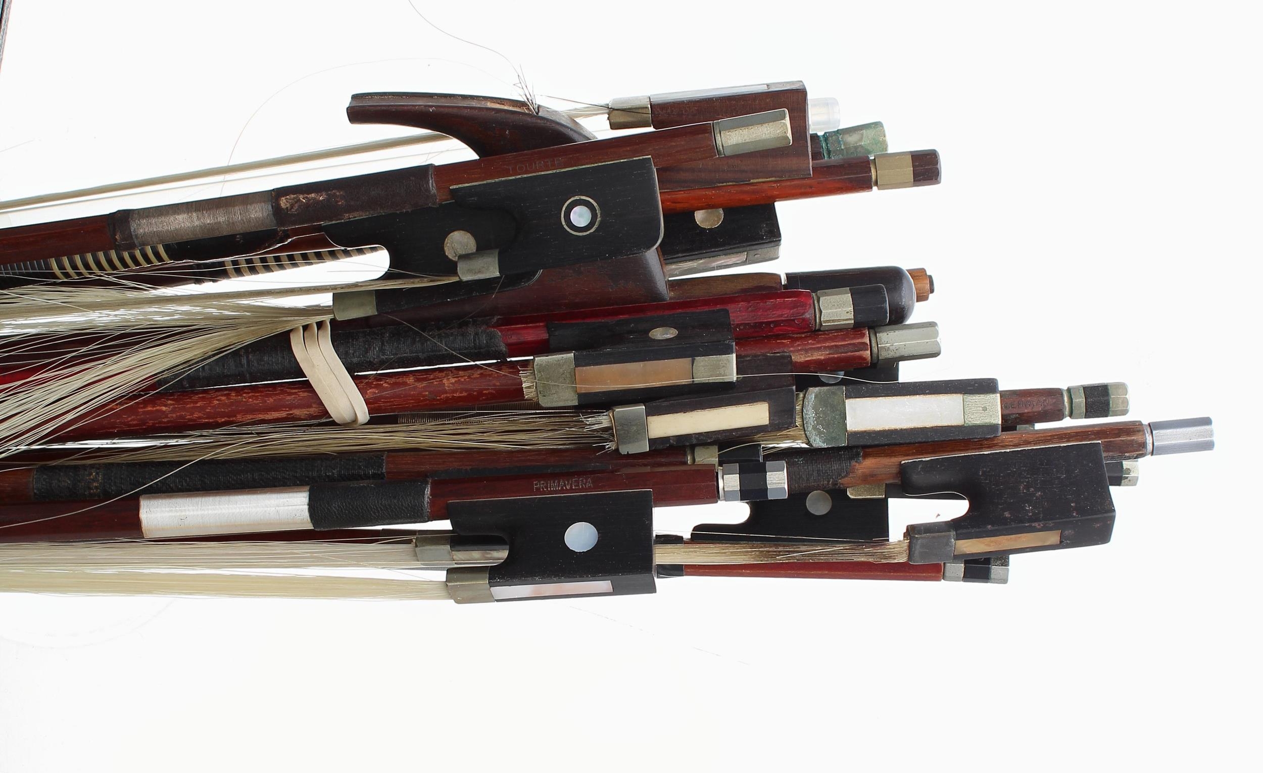 Bundle of various bows including one bass bow