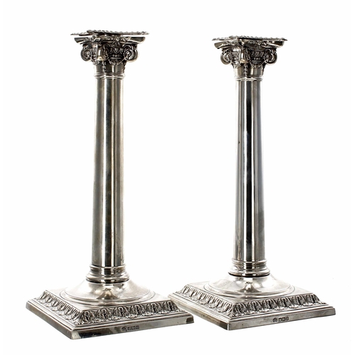 525 - Pair of Edwardian Corinthian column silver candlesticks by William Hutton & Sons Ltd., with scro... 