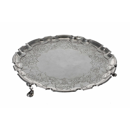 548 - George II Scottish circular silver card tray, with shallow chased foliate and fruits border within a... 