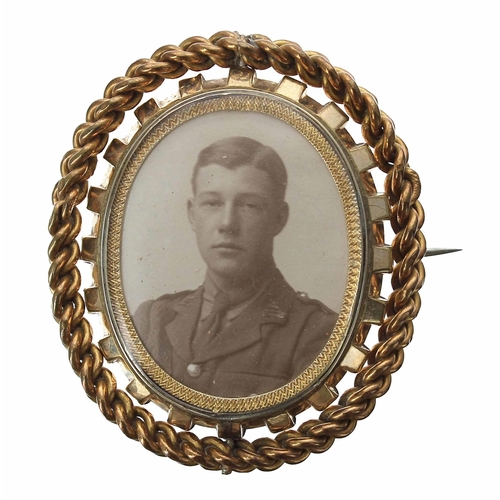 669 - Good large swivel photograph mourning brooch, bearing the portrait of a uniformed officer opposite l... 