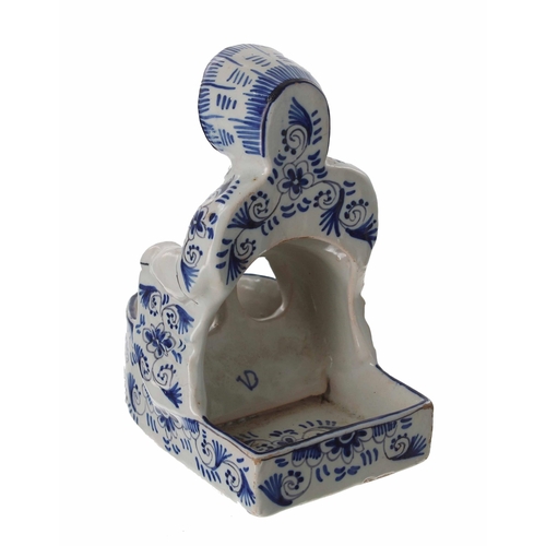 723 - Dutch Faience glazed blue and white novelty pottery figure of a lady, modelled kneeing with holes at... 