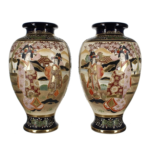 749 - Pair of Japanese Satsuma baluster vases, decorated with figures in a garden, trees in blossom, beari... 