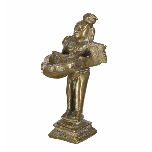 772 - Indian bronze figure of Deepalakshmi, cast standing and holding the oil lamp font dish, 5