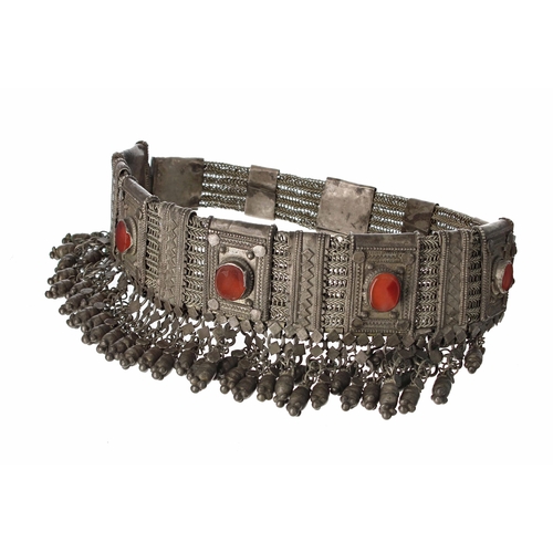 769 - Yemeni metal headdress, decorated with six inset orange stone roundels on a fancy chain link band wi... 