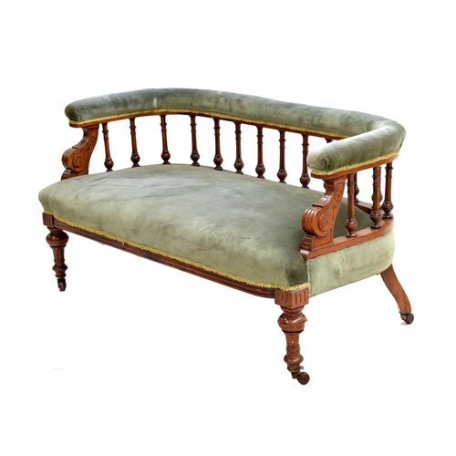 975 - Victorian spindle-back salon settee, the curved back and seat in green stuff-over upholstery, raised... 