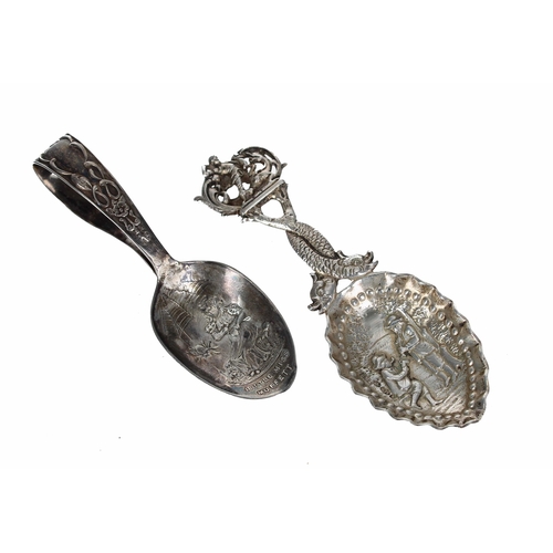 580 - Dutch silver 925 caddy spoon, with a figural finial and dolphin handle, the bowl repousse cast with ... 