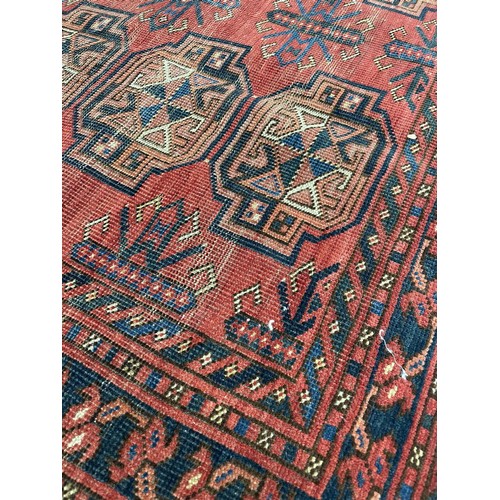 916 - Small red ground Persian pattern rug, labelled The Anglo Persian Carpet Co. Direct Importers.., 34