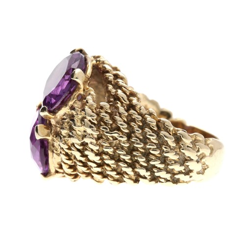 353 - Large 9ct yellow gold corundum set ring, set with two oval purple coloured stones in a rope twist de... 