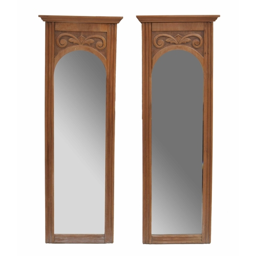 954 - Pair of decorative satin walnut wall mirrors, with bevelled arched glass within a frame surmounted b... 