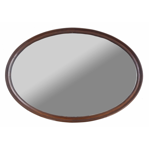 983 - Oval mahogany wall mirror, with bevelled glass within a moulded frame, 38