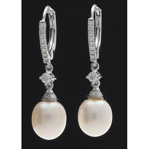 300 - Pair of 18ct white gold cultured pearl and diamond earrings, the pearls 7mm, hinged backs, 3.6gm, 32... 