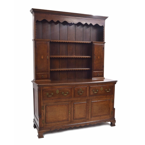 982 - Good George III oak and mahogany crossbanded dresser, the raised panelled back with a shaped frieze ... 