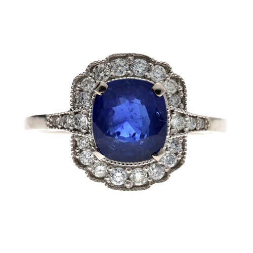 Attractive 18ct blue sapphire and diamond cluster ring, the square cushion sapphire estimated 1.60ct approx, in a millegrain setting of round brilliant-cut diamonds, width 15mm, 4.8gm, ring size R