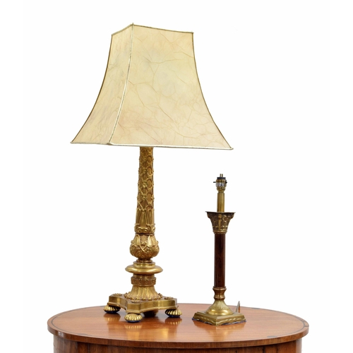 642 - Decorative heavy cast gilt metal table lamp, raised o a quatrefoil base over gadrooned feet, with sq... 