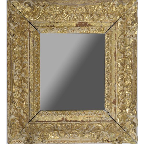 974 - 18th century gilt and gesso framed mirror, the plain glass with some patina, within a wide foliate m... 