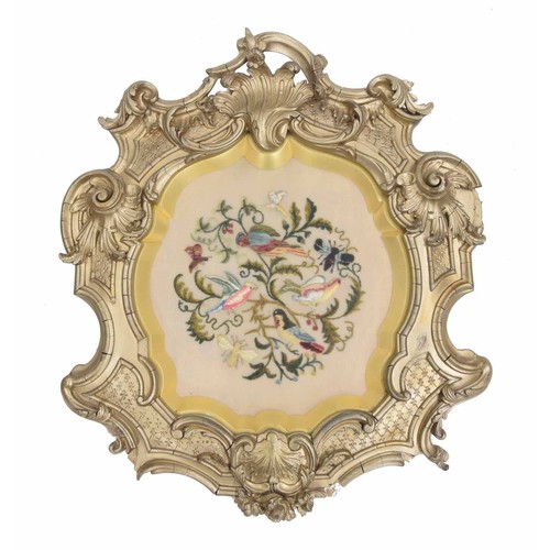 19 - 19th century needlework picture, depicting birds and other wildlife among foliage, in a shaped mount... 