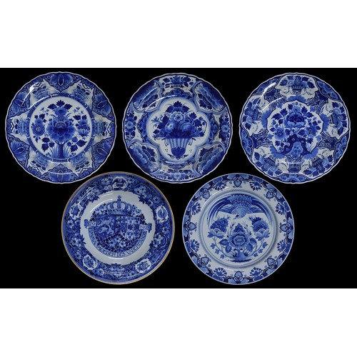 22 - Five Dutch Royal Delft, Porcelyne Fles blue and white deep dished pottery chargers, decorated with a... 