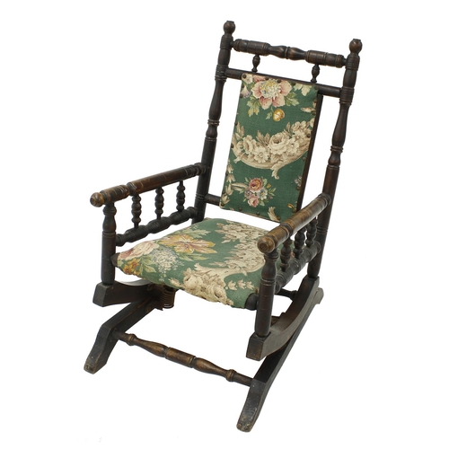 1629 - Late 19th century American child's rocker armchair, with foliate padded back and seat and turned sup... 