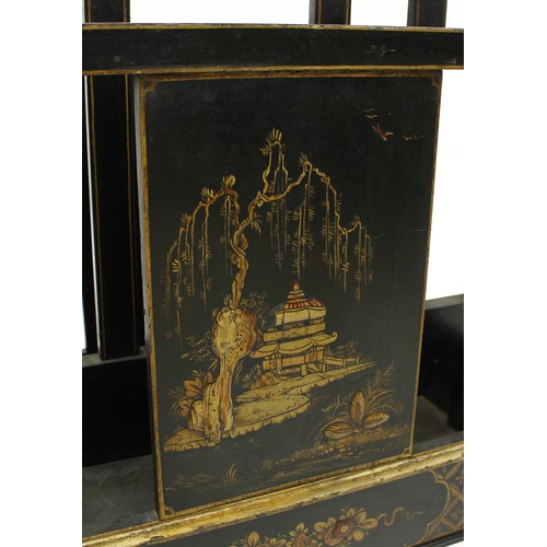 1633 - Decorative chinoiserie black lacquered two division Canterbury decorated with pagoda landscapes, fol... 