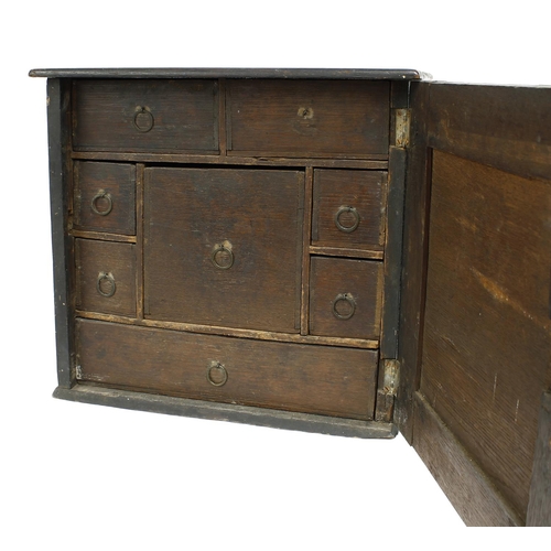 1686 - 18th century oak spice cabinet, the geometric panelled door enclosing an interior with eight small d... 