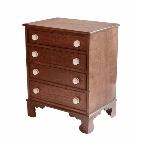 1702 - Oak four drawer chest of small proportions, with graduated drawers applied with matching white ceram... 