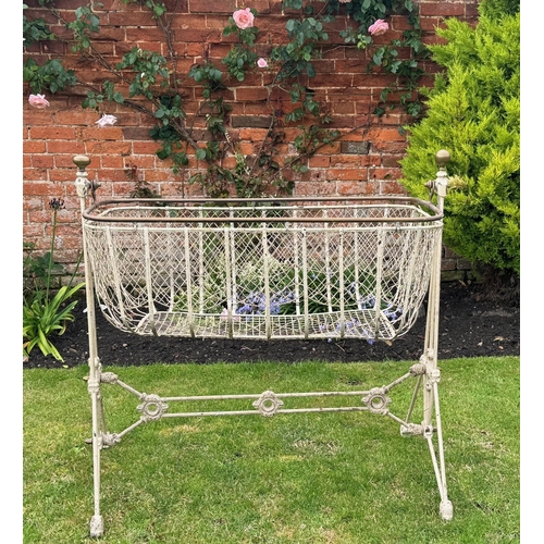 1715 - Victorian painted wrought iron swing cot on stand, with brass finials and brass top rail over a wire... 