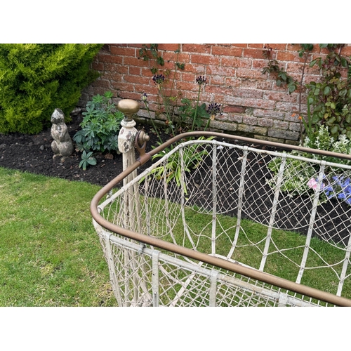 1715 - Victorian painted wrought iron swing cot on stand, with brass finials and brass top rail over a wire... 