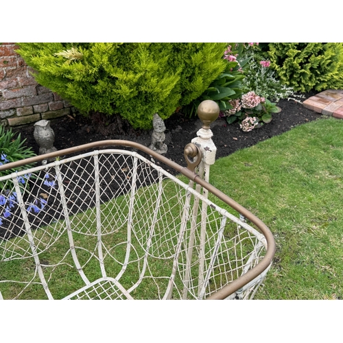 1715 - Victorian painted wrought iron swing cot on stand, with brass finials and brass top rail over a wire... 